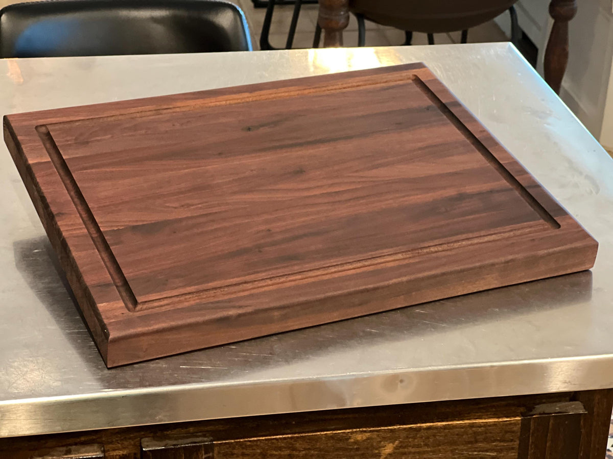 Edge grain Walnut cutting board with juice grove