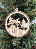 This is a round wooden Christmas ornament with a winter scene with a living hinge. It’s Santa on his midnight run.