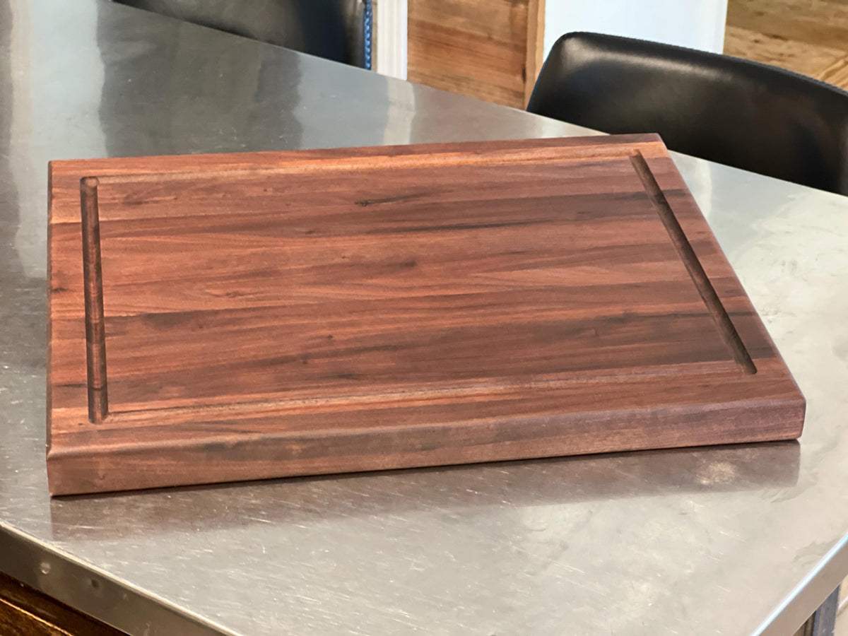 Edge grain Walnut cutting board with juice grove