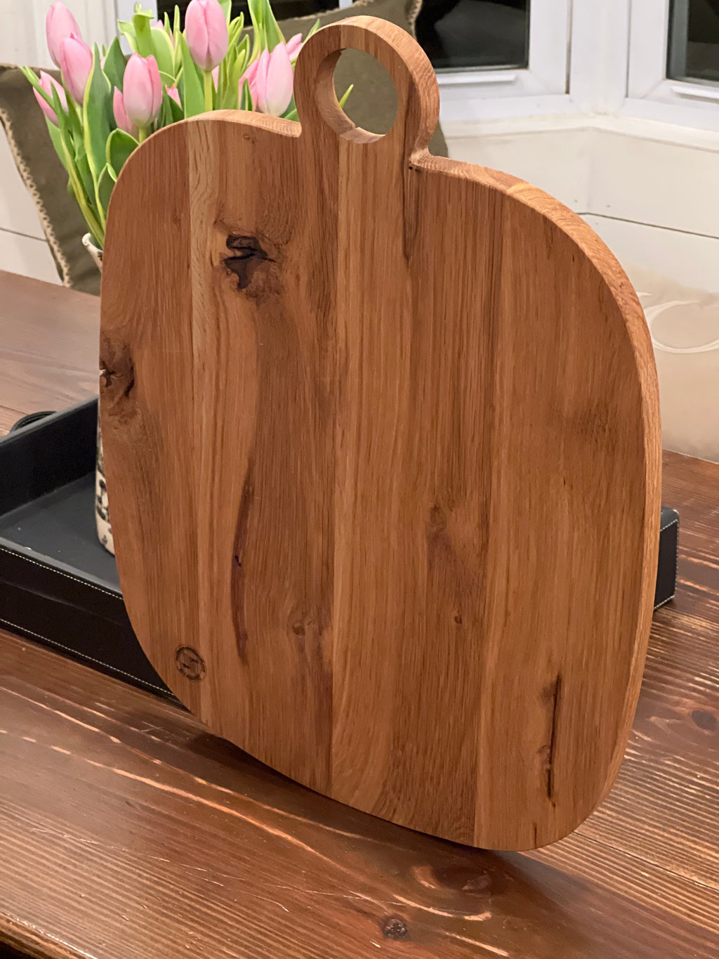 This is a 14” x 18” organic, circular handle, Maple cutting board/Homeware