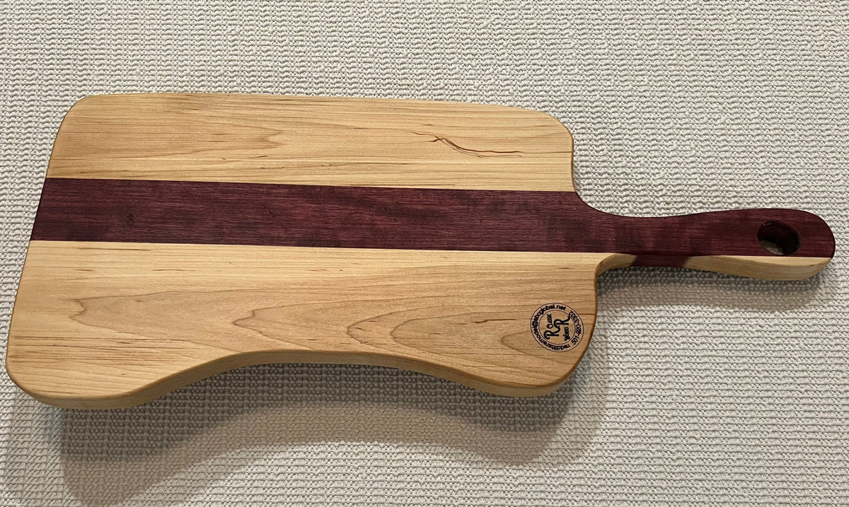 This is a handmade, solid wood, custom design handle cutting board.