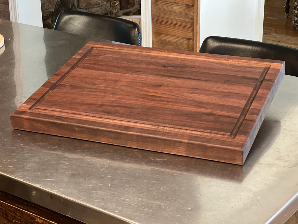 Edge grain Walnut cutting board with juice grove