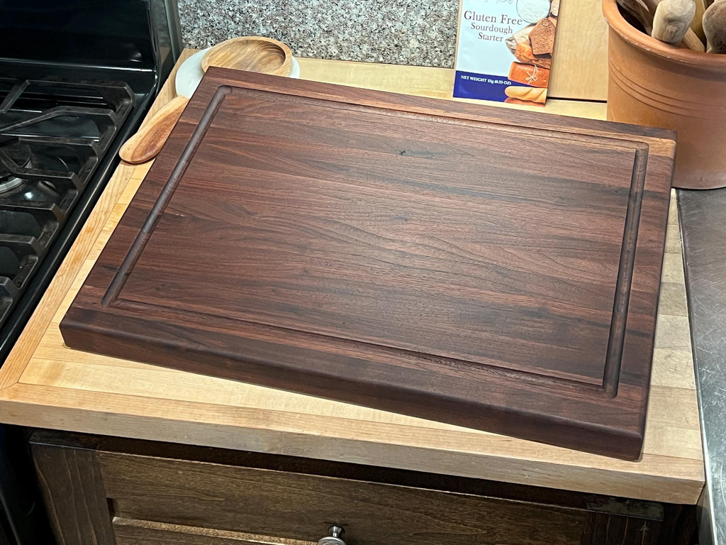 Edge grain Walnut cutting board with juice grove
