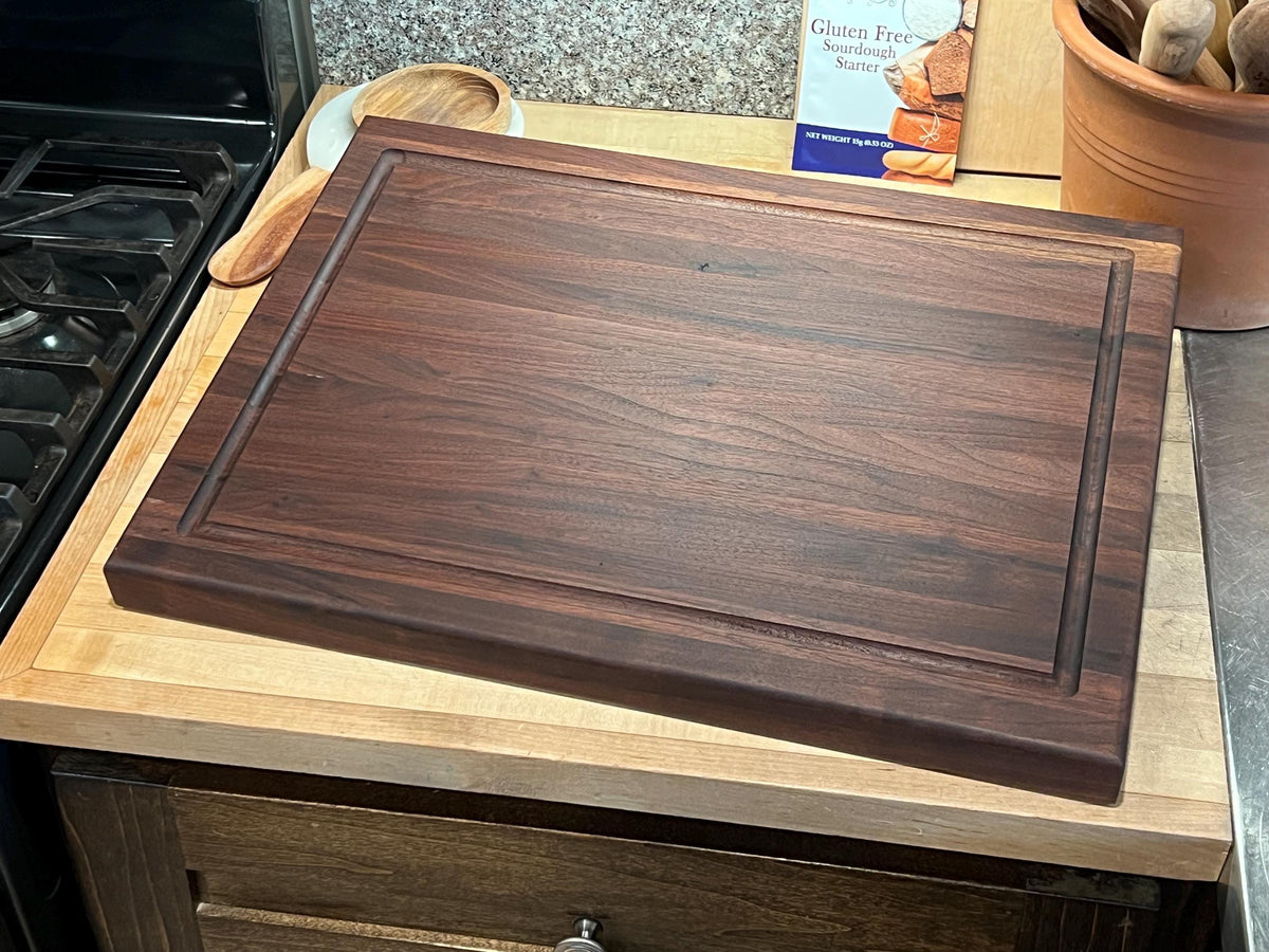 Edge grain Walnut cutting board with juice grove