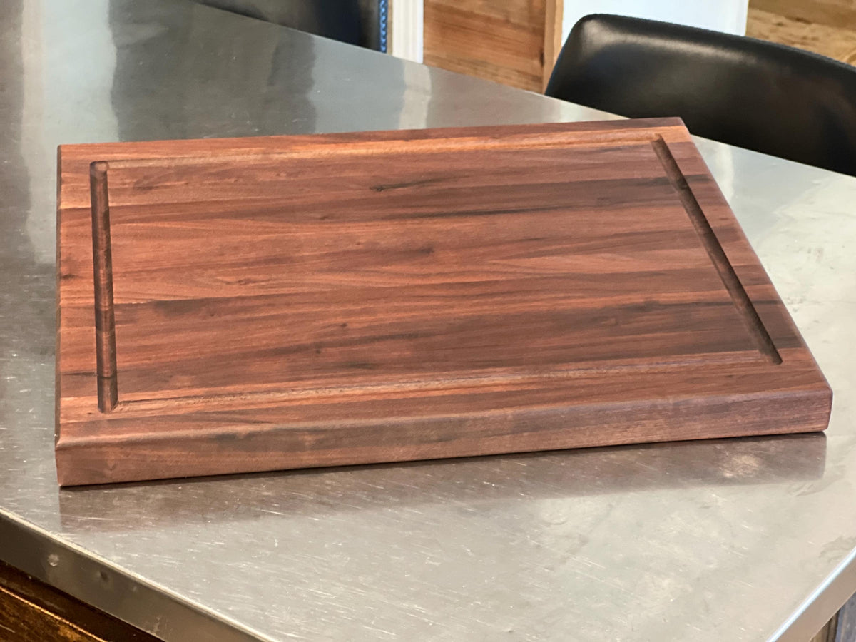 Edge grain Walnut cutting board with juice grove
