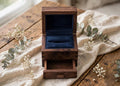 Classic craftsman style — lift-top ring section with a pull-out drawer underneath for the second band, notes, or keepsake