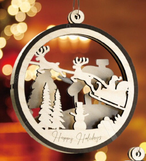 This is a round wooden Christmas ornament with a winter scene with a living hinge. It’s Santa on his midnight run.