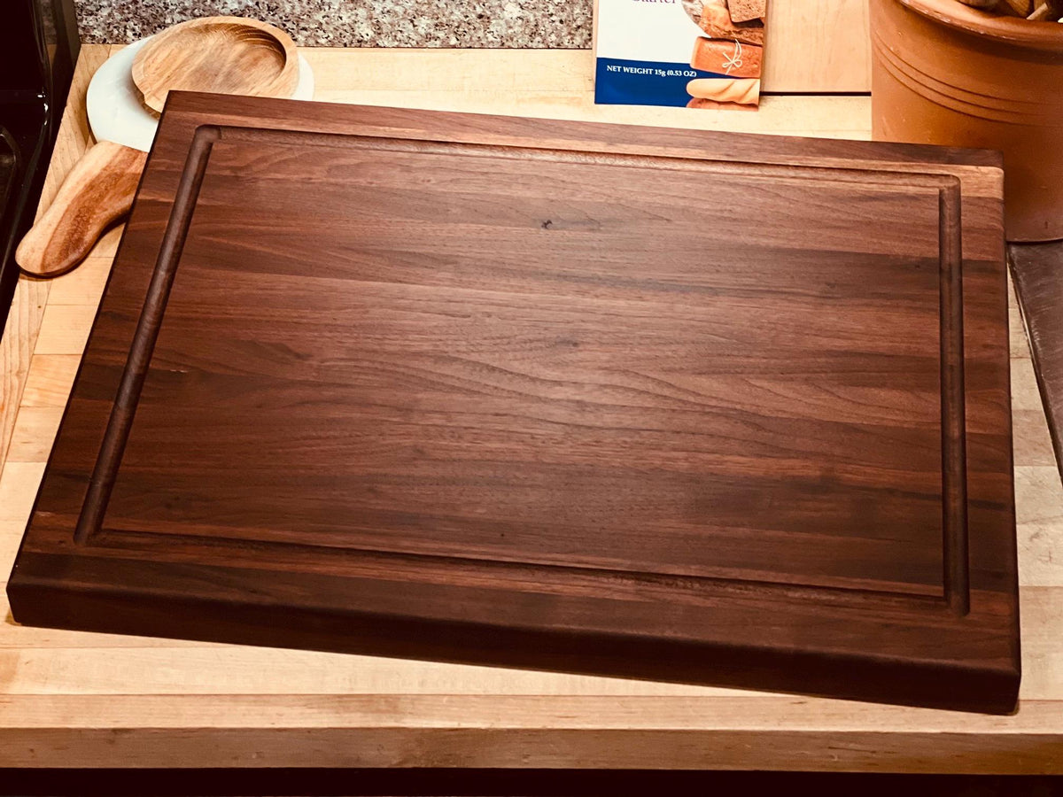 Edge grain Walnut cutting board with juice grove