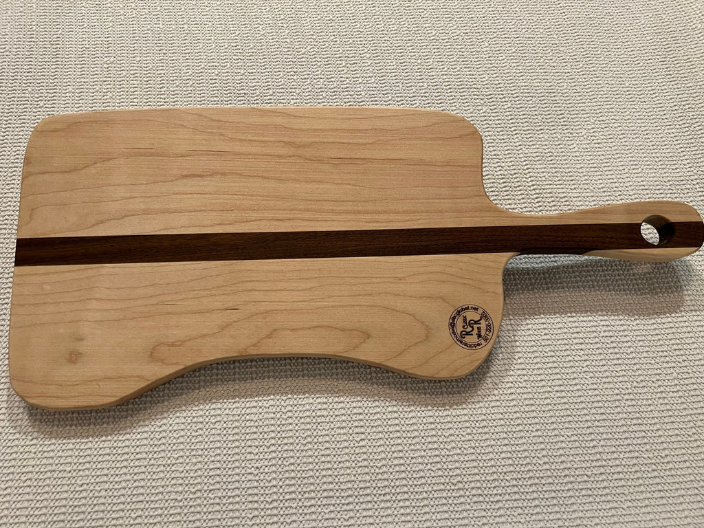 This is a handmade, solid wood, custom design handle cutting board.