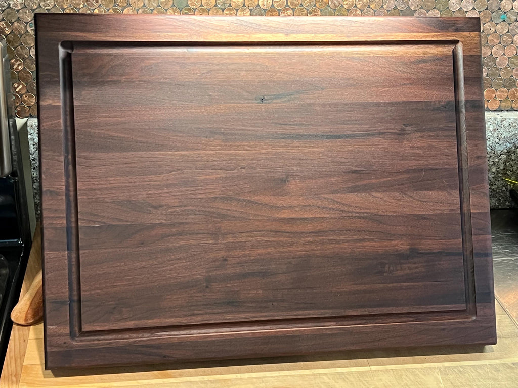 Edge grain Walnut cutting board with juice grove