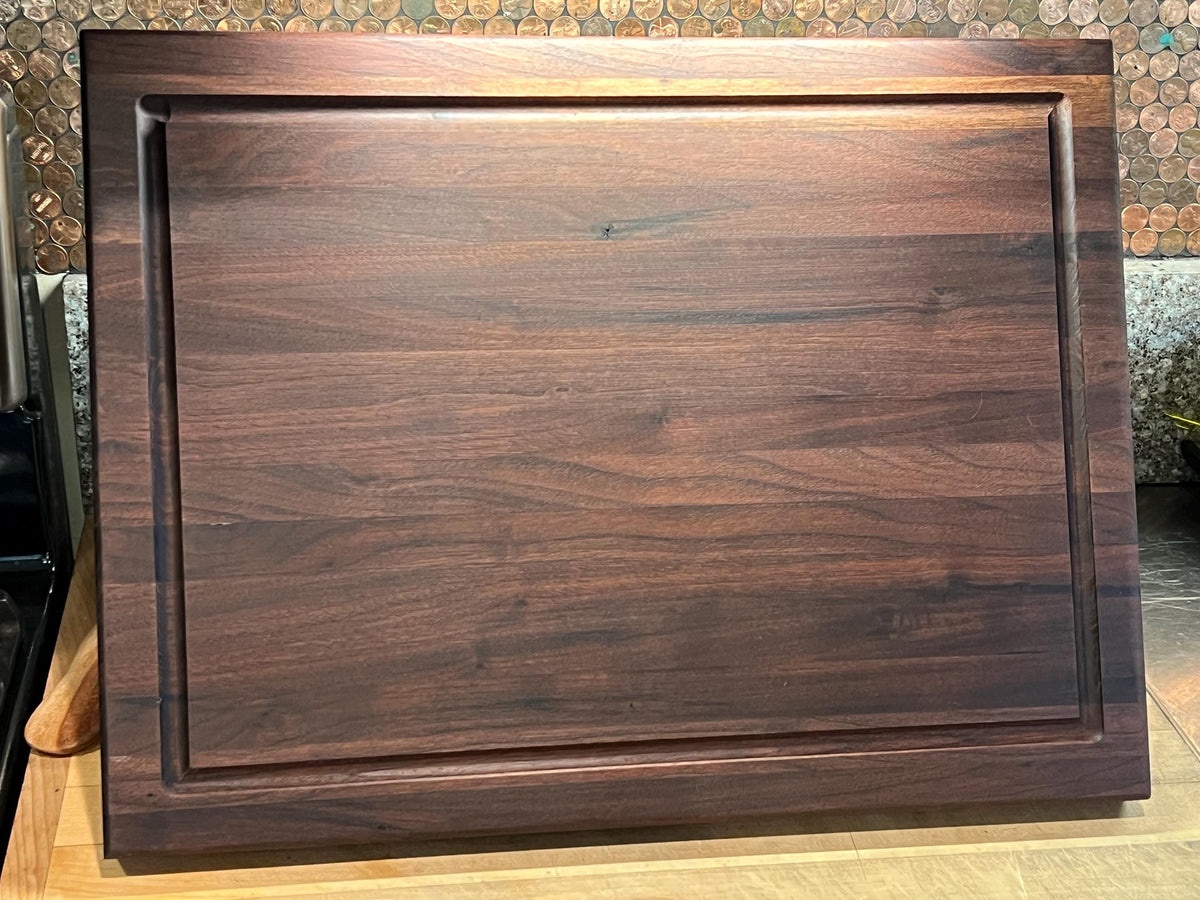 Edge grain Walnut cutting board with juice grove