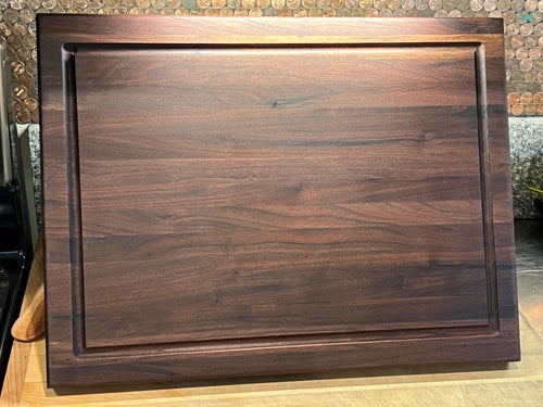 Edge grain Walnut cutting board with juice grove